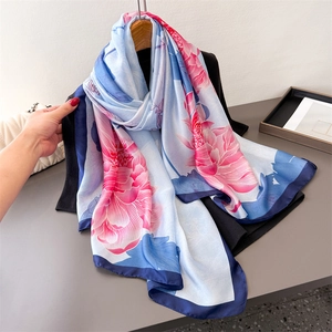 Long faux silk scarf with pink lotus print and dark blue border on light blue satin