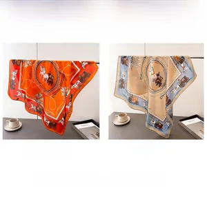 Detail of luxury horse carriage print silk scarves in orange and beige brown tones