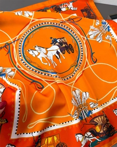 Detailed macro view of classic silk scarf with vintage horse carriage print and crown motifs