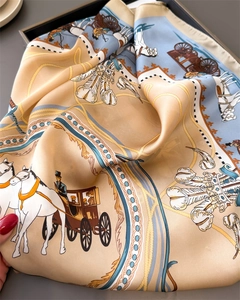 Macro detail of silk scarf featuring retro carriage prints and smooth satin texture