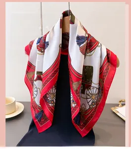 Macro view of silk square scarf featuring classic equestrian patterns and red borders