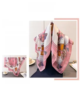 Close-up of pink silk scarf featuring vintage carriage patterns and elegant fringe details