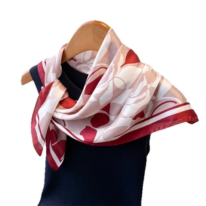 Elegant rose floral satin square scarf draped on a black top for versatile styling