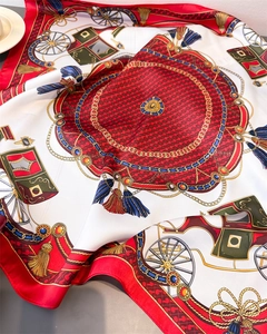 Detail of luxury silk scarf with vintage carriage print and tassel patterns in red