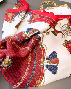 Detail of silk-textured square scarf featuring vintage carriage and gold chain patterns