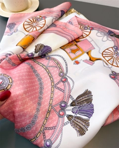 Macro detail of silk scarf featuring pink carriage prints and premium glossy texture