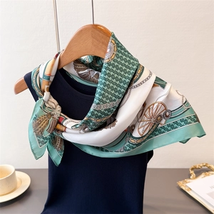 Close-up of silk square scarf with mint green vintage horse carriage and chain print