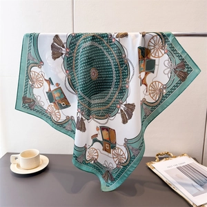 Detail of silk scarf with classical horse carriage print and golden tassel patterns