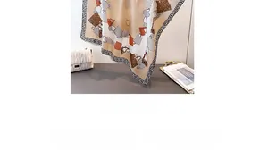 Detailed close-up of brown leopard print silk scarf featuring elegant handbag patterns
