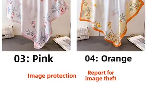 Détail de foulards en soie rose et orange avec un motif floral élégant