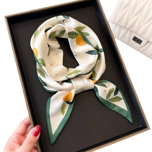 Fresh lemon pattern silk scarf with green borders presented in a gift box