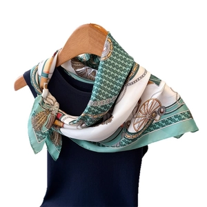 Fashionable silk scarf with mint green equestrian prints and golden chain patterns