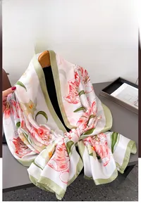 Detail of floral silk scarf with pink tulips and green border on a white base