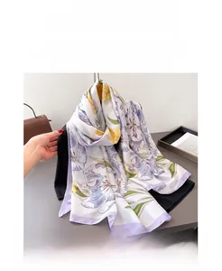 Close-up of floral silk scarf showing purple tulip patterns and rolled edge detail