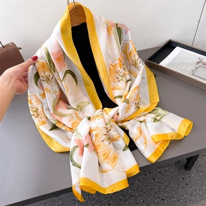 Elegant floral silk satin long scarf with yellow tulip print on a wooden hanger
