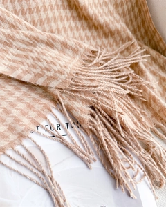 Detailed close-up of apricot houndstooth scarf with elegant long fringes for winter