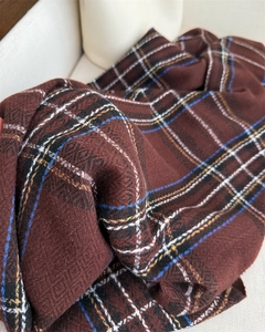 Detail of soft twill weave and retro plaid pattern on a thick cashmere-like scarf
