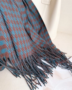 Close-up of houndstooth scarf texture with fringe details and soft imitation cashmere fabric