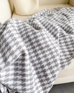 Close-up of classic grey and white houndstooth scarf texture with soft woven details