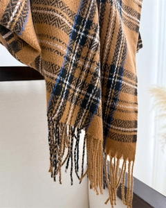 Close-up of retro plaid scarf with fringes and thick cashmere-like texture for winter