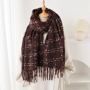 Detail of dark brown plaid cashmere scarf with soft fringe and classic check pattern