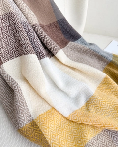 Detailed macro view of soft cashmere-like knit fabric with multi-color geometric patterns