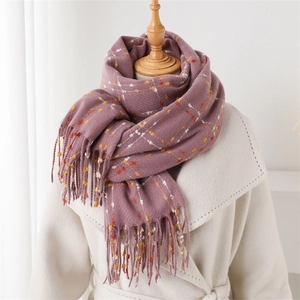 Close-up of soft plaid cashmere-like scarf with long tassels on a mannequin display