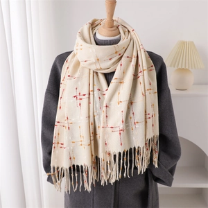 Elegant cream plaid cashmere shawl with fringe tassels over a gray winter wool coat