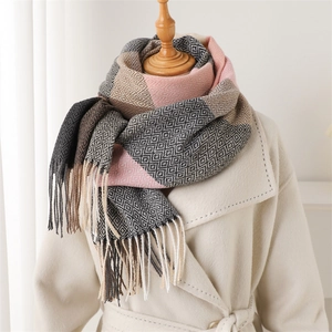 Close-up of cashmere-style scarf with geometric plaid patterns and fringe details