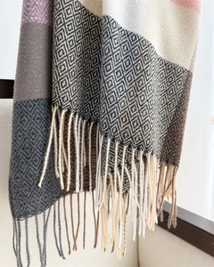 Detailed view of color-block plaid scarf with geometric diamond knit and soft tassels