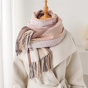 Detail of color-block striped scarf with soft tassels on a mannequin in a cozy setting