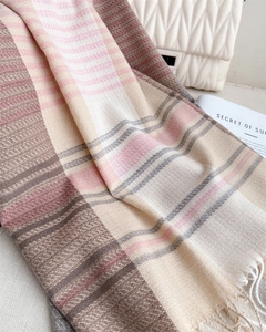 Close-up of color-block striped scarf with soft fringe details and woven texture