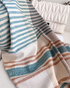 Close-up of multicolor striped cashmere-like scarf texture with soft fringe detail
