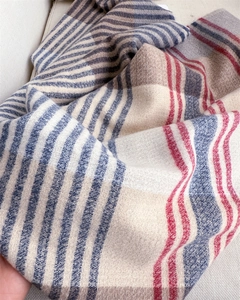 Close-up of soft color-block striped scarf with premium woven texture on fabric