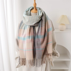 Close-up of soft cashmere-feel scarf with blue stripes and color-block fringe detail