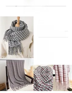 Detail of plaid patterned cashmere-feel scarf with long fringe trim for autumn and winter
