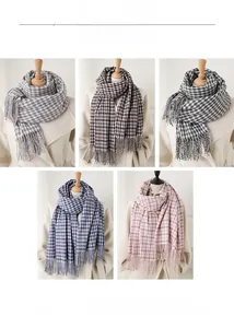 Close-up of soft plaid scarves with fringe details in grey, burgundy, and blue tones