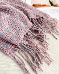 Détail d'une écharpe à chevrons rose et gris avec franges douces et texture cachemire