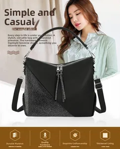 Detail of black pebbled leather handbag with silver rhinestone panel and tassel zippers