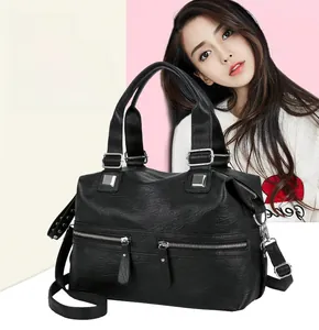 Detail of black PU leather handbag showing parallel front zippers and silver hardware finish