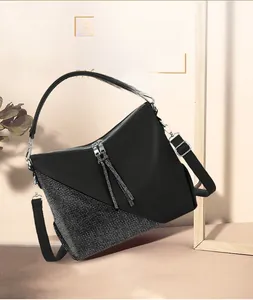 Detail shot of vintage black leather shoulder bag with decorative sparkling rhinestones