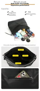Detail view of large black crossbody bag showing internal compartments and back phone pocket