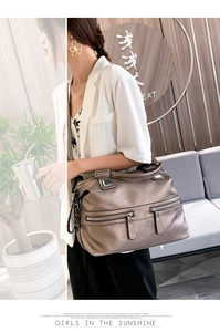 Detail of soft leather tote bag with functional double zippers and metallic gold finish