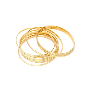 Chic gold metal bangle set featuring sandblasted matte and smooth polished finish rings