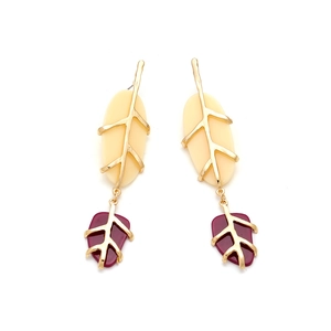 Detailed macro view of vintage resin leaf earrings with gold metal frame and dangling petals