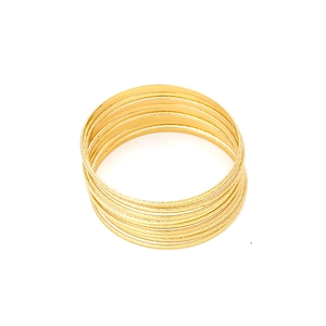Set of gold textured thin bangle bracelets with sandblasted finish and minimalist metal style