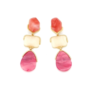 Detail of geometric drop earrings with gold frames and marble-textured resin segments
