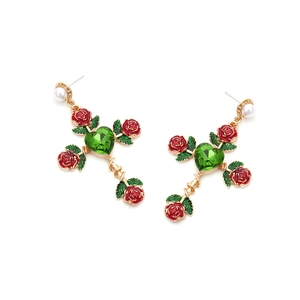 Detail view of cross earrings featuring red enamel roses and green heart crystals