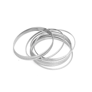 Macro detail of silver-tone stackable rings with sparkling frosted texture and metallic finish