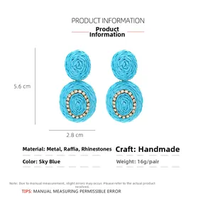 Detail view of sky blue raffia earrings with rhinestone circles and size dimensions